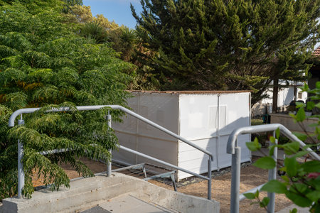 A structure stands in a garden, surrounded by greenery.の写真素材