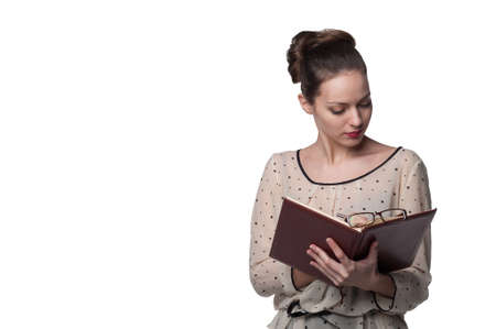 Young beautiful woman holding a notepad on white background