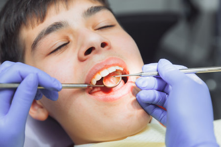 The dentist examines the teeth of a boy of 13 years old in the clinic. pediatric dentistryの写真素材