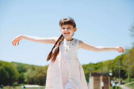 happy child on the beach.little blonde girl runs along the sand on the beach.の写真素材
