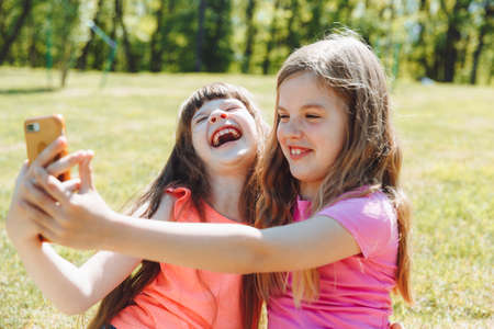 keep a blog. Little girls take a selfie for a blog. video call. Online social networks.の写真素材