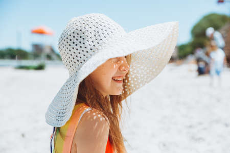 Summer portrait of a little girl outdoors on the beach. summer holidays.girl in a hat