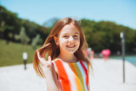 Summer portrait of a little girl outdoors on the beach. summer holidays.girl in a hatの写真素材
