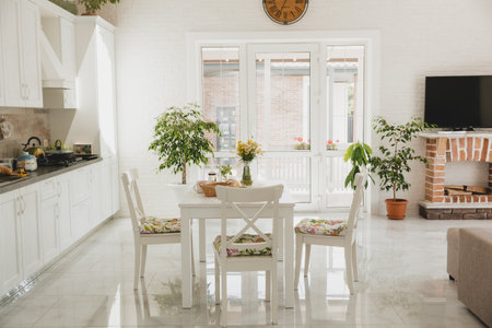 Luxurious home interior with living room next to kitchen and glass door facing outsideの写真素材