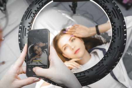 A person takes a photo of his client on his phone.