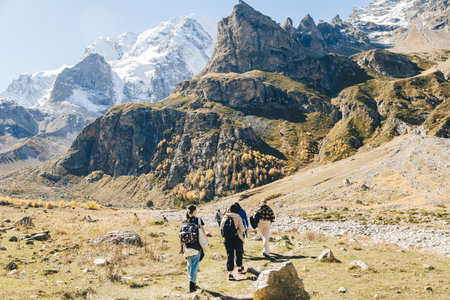 group of tourists goes to snowy peaks. trekking in the mountains. Ullu-Tau mountain....