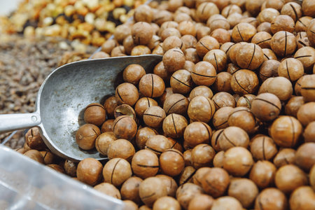 Lots of macadamia nuts in a box being sold at the market, selective focusの写真素材