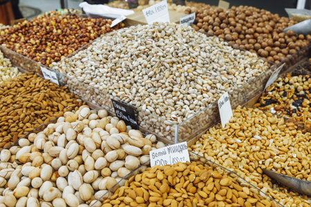 assortment of various nuts on the counter of an oriental bazaar. Almonds, pistachios and other nutsの写真素材