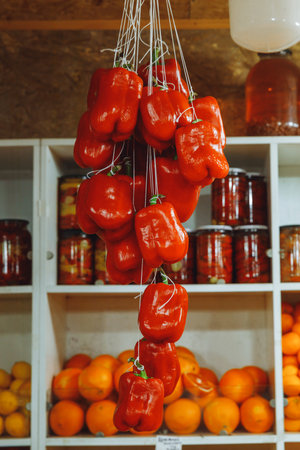 a bunch of red bell peppers sold at a street market.