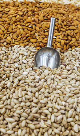 assortment of various nuts on the counter of an oriental bazaar. Almonds, pistachios and other nuts