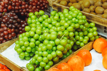 A fresh bunch of shiny muscat grapes at the market. Shine Muscatの写真素材