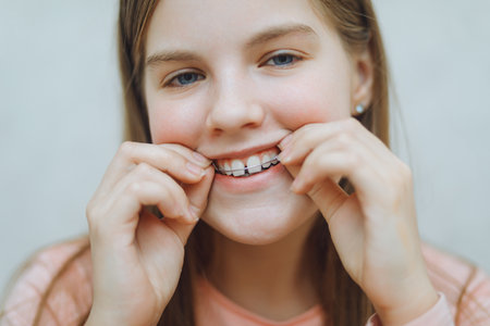 Close-up portrait of a girl with braces on her teeth.