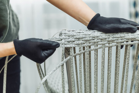 rattan furniture, a woman makes an artificial rattan chair. handmadeの写真素材