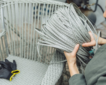 rattan furniture, a woman makes an artificial rattan chair. handmadeの写真素材