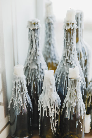 corked wine bottles decorated with melted candle waxの写真素材