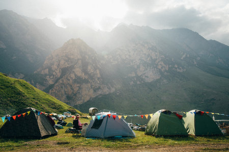 Camping in the mountains with colorful flags and tents