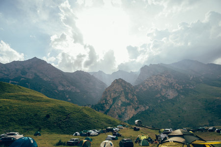 Camping in the mountains with colorful flags and tents