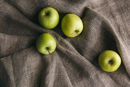 Ripe green apples on a rustic cloth.の写真素材