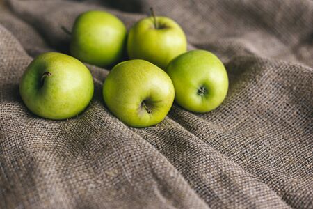 Ripe green apples on a rustic cloth.の写真素材