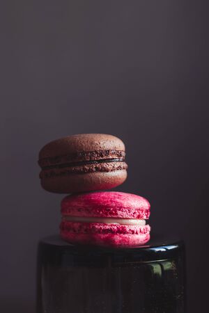 Raspberry and chocolate French macarons on dark background.の写真素材