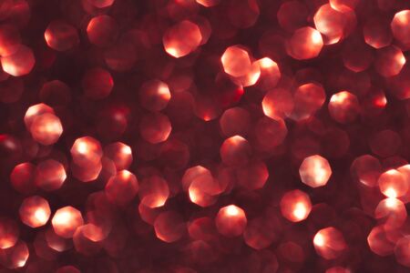 Abstract red background. Shiny glitter bokeh in red colors.の写真素材