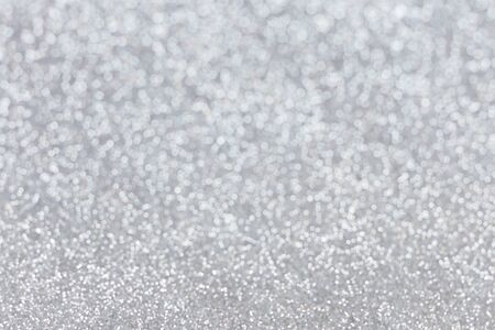 Abstract silver glitter background. Sparkle silver bokeh christmas background.の写真素材