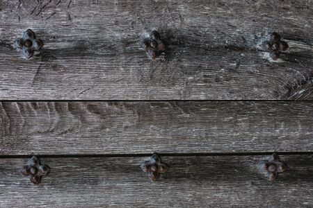 Rustic wood texture or background. Old wooden door with iron rivets.  Close-up.の写真素材