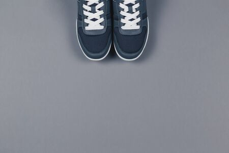 Grey sneakers on the grey background. Concept for healthy lifestyle and everyday training.  Place for text. の写真素材