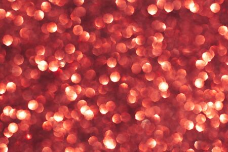 Abstract red background. Shiny glitter bokeh in red colors. Selective focus.の写真素材