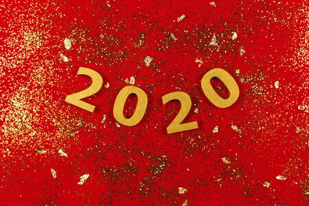 Happy New Year festive background with golden numbers 2020 and golden sparkles. Flat lay.の写真素材