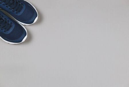 Classic blue sneakers on the grey background. Concept for healthy lifestyle and everyday training.  Place for text. の写真素材