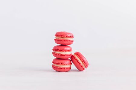 Tasty french macaroons with small flowers on a white background.  Place for text.の写真素材
