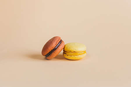 Tasty french macarons on a peach pastel background. Place for text.の写真素材