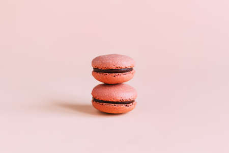 Tasty french macaroons on a pink pastel background. Place for text.の写真素材