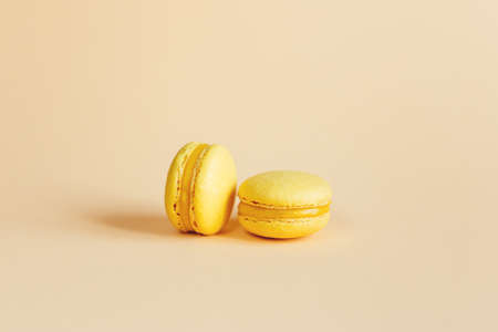 Macarons isolated on yellowの写真素材