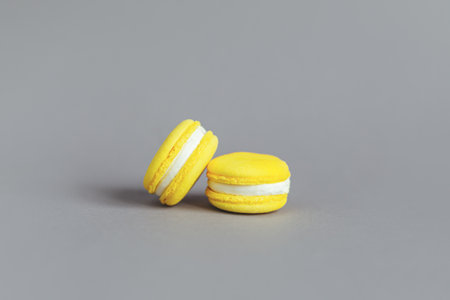 Tasty french yellow macaroons on a gray background. Place for text.の写真素材