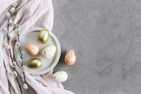 Easter background with eggs and spring willow branches. Pastel colors. Flat lay.の写真素材