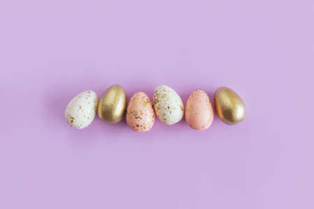 Easter eggs on a pastel violet background. Pastel colors. Flat lay. Place for text.の写真素材