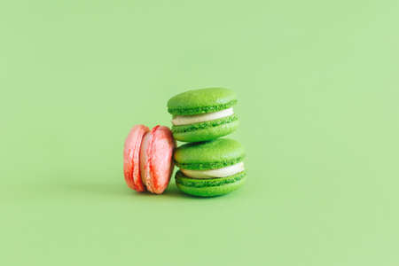 Tasty french macarons on a green pastel background. Place for text.の写真素材