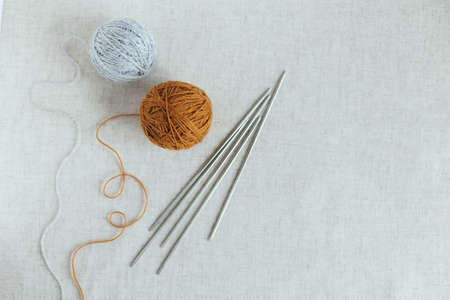 Cozy ball of yarn and needles for knitting. Background for handmade and slow homelife. Place for text.の写真素材