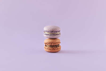 Tasty french macarons on a violet pastel background. Place for text.の写真素材