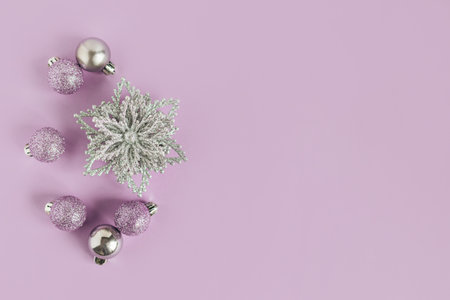 Christmas ornaments on a violet pastel background. Christmas background. Flat lay. Place for text.の写真素材