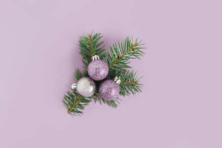Spruce branches and christmas ornaments on a violet background. Christmas background. Flat lay. Place for text.の写真素材