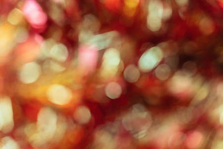 Shiny glitter bokeh in red colors. Abstract red background. Selective focus.の写真素材