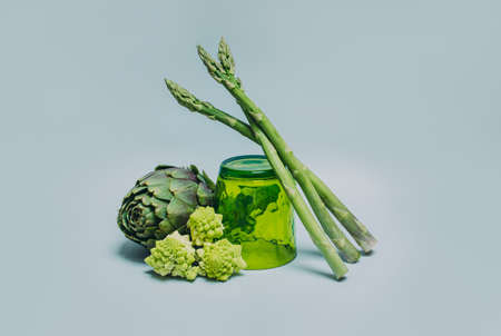Fresh Artichoke, Asparagus and Romanesque cabbage on a gray background. minimal concept.の写真素材