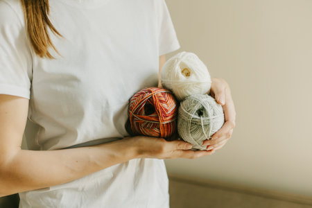 Girl with yarn skeins in a hands for knitting. selective focus.