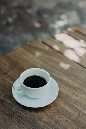 Cup of black coffee on a table in a street cafe. selective focus. Place for text.の写真素材