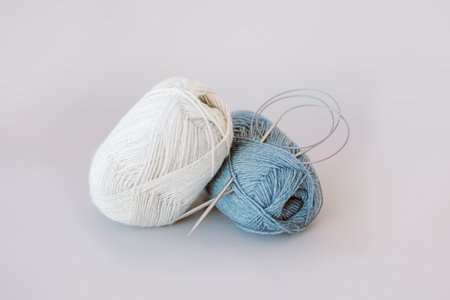 Skeins of woolen yarn and knitting needles for hand knitting. Concept for handmade.の写真素材