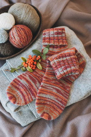 Hand knitted socks with needles and yarn ball. Concept for handmade and hygge slow life. flat lay.の写真素材