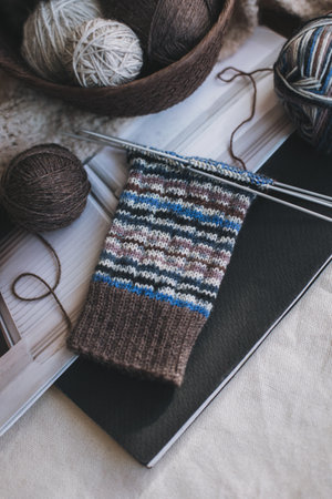 Hand knitted socks with needles and yarn balls. Concept for handmade and hygge slow life.の写真素材